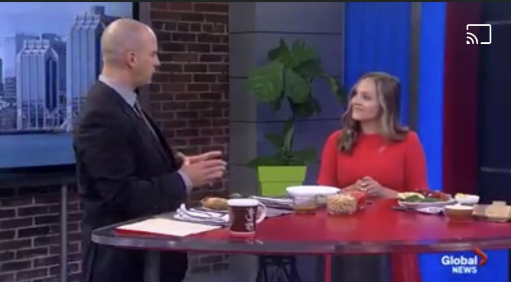 Hannah Magee in a TV studio and talking to a TV host.